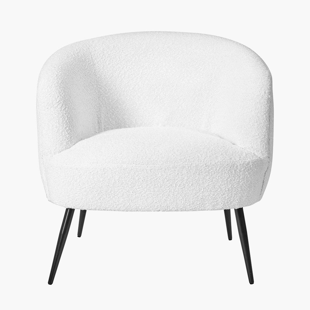 White boucle barrel chair with curved back and black metal legs
