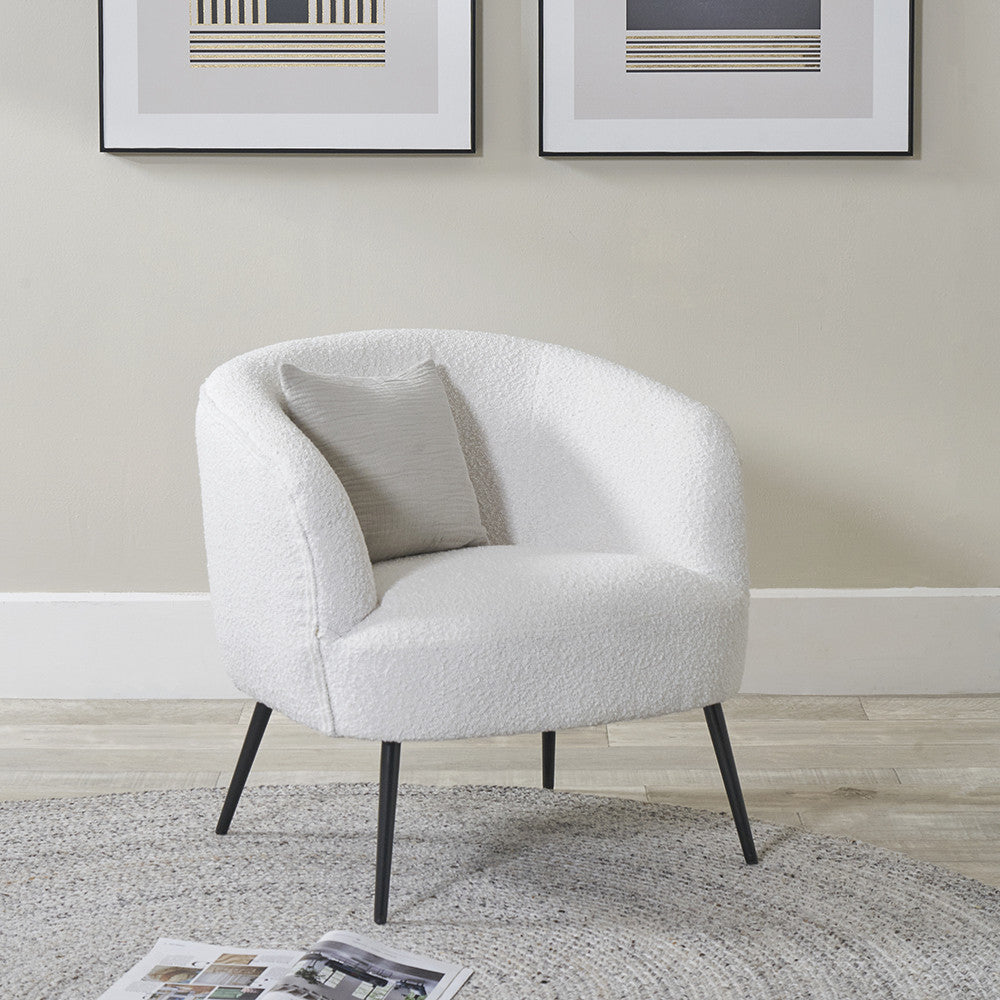 Boucle accent chair with white fabric and black metal legs, rounded armrests
