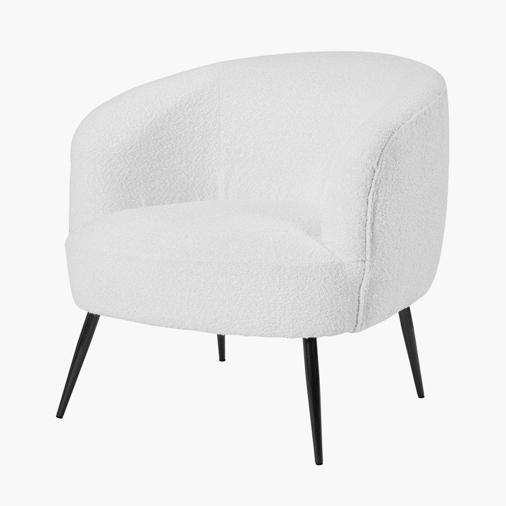 White boucle accent chair side view with curved seat and black tapered legs