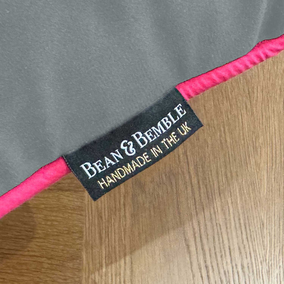 Label on a product with 'Bean & Bemble' branding and text 'Handmade in the UK' on a gray and pink background.