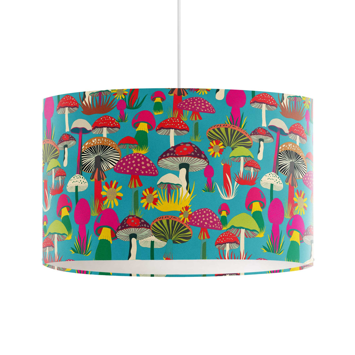 A drum pendant lamp shade featuring a vibrant, multicolored mushroom forest pattern on a turquoise blue background, suspended by a white cord against a plain white studio backdrop.