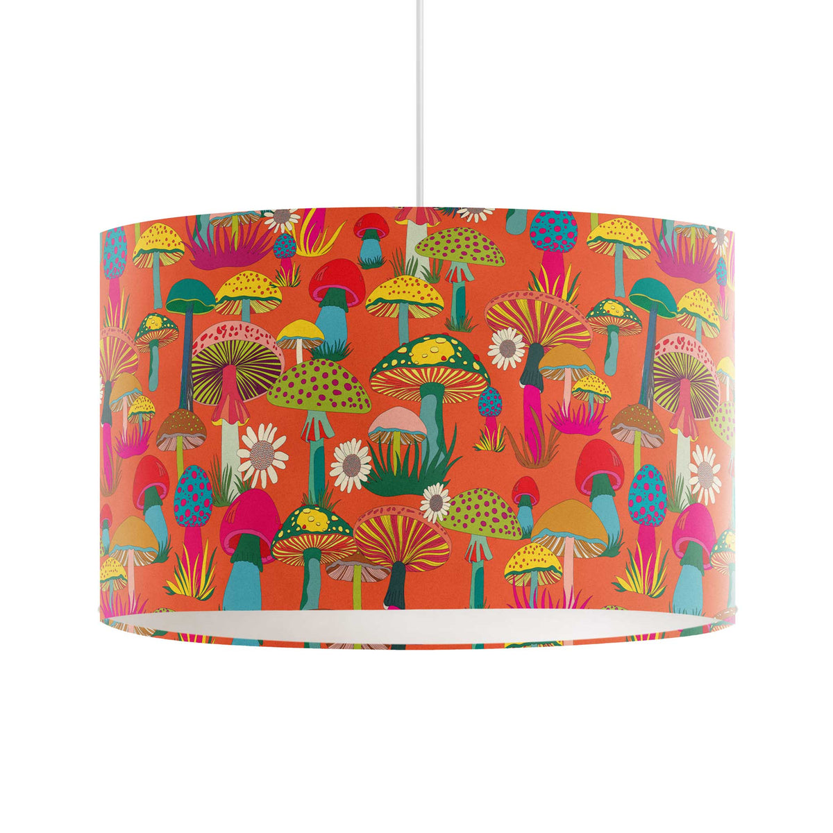 A drum-shaped pendant lampshade featuring a vibrant, multicolored retro mushroom pattern on a bright orange background, suspended by a thin white cord against a plain white wall.