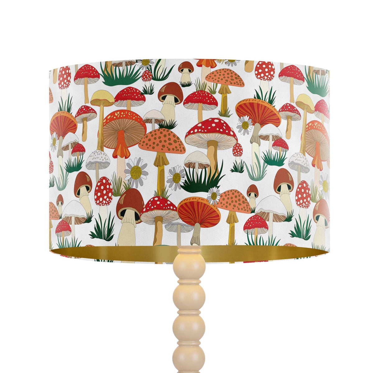 A table lamp with a white drum shade covered in a colourful mushroom print and a turned light wood pedestal base, shown on a plain white background.
