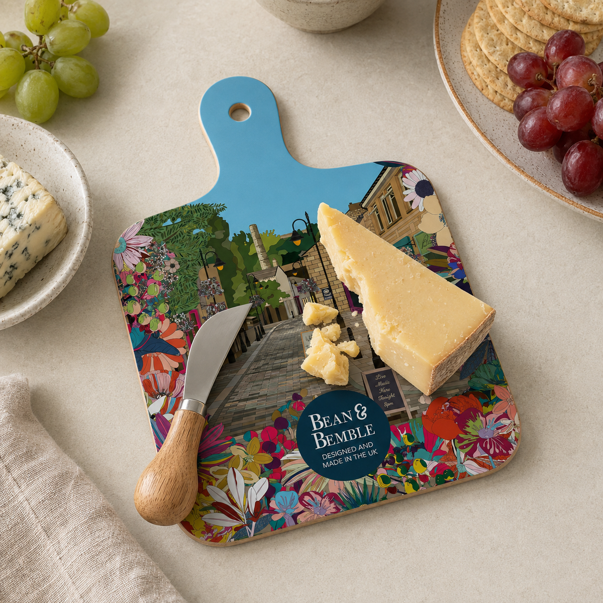 Mini Bean & Bemble chopping board with illustration, hanging hole, and cheese portion