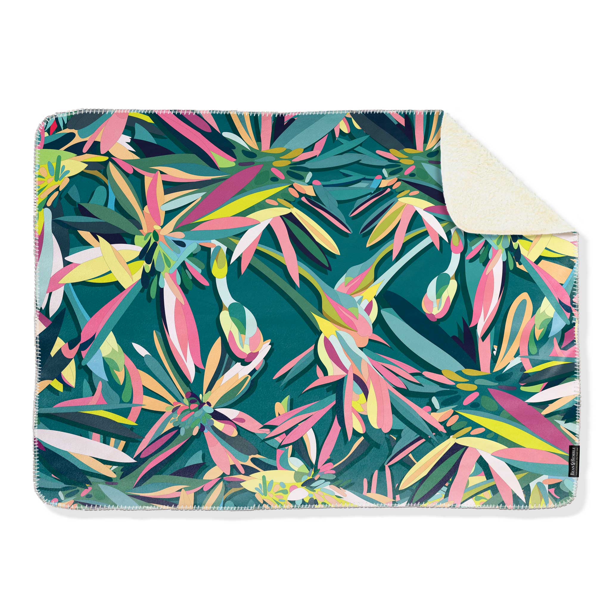 Colourful teal abstract patterned blanket on a white background