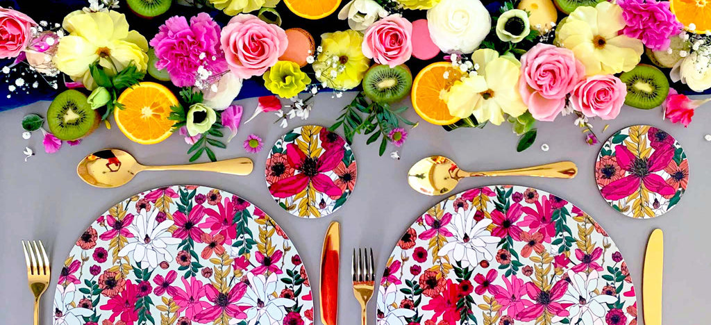 Beautiful colourful tablescape featuring melamine placemats by Bean and Bemble, summer fruits and pretty flowers