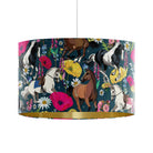 A drum pendant lamp with a dark navy blue background and a detailed pattern of horses and wildflowers, finished with a metallic gold interior rim.