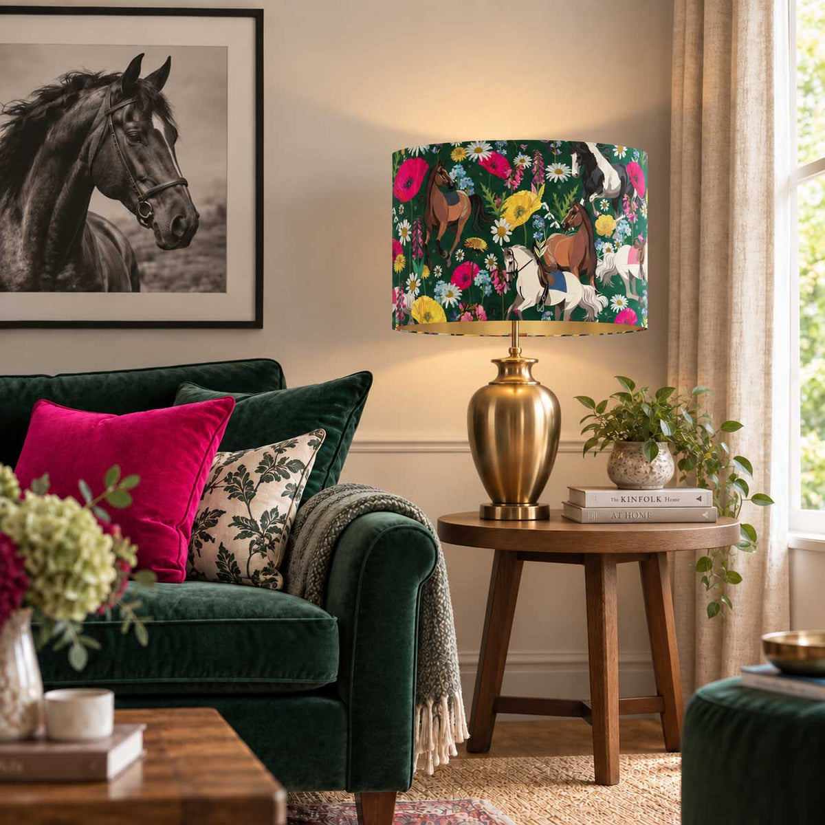 Equestrian Meadow velvet horse lampshade on a brass table lamp beside a deep green velvet sofa with hot pink cushion and black and white horse wall art.