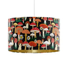 Black mushroom velvet drum lampshade with matte gold inner, shown as a ceiling pendant with hand-illustrated toadstools and daisies.