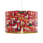 Mad Mushrooms red velvet drum lampshade with hand-illustrated toadstools, mushrooms and daisies, shown as a ceiling pendant with matte gold inner.