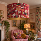 Mad Mushrooms red velvet ceiling pendant lampshade styled in a colourful cottagecore living room with patterned furniture and cosy maximalist decor.