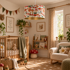 A nursery room decorated in a warm woodland theme, featuring a prominent drum pendant light with a colorful mushroom and forest pattern, a wooden crib, a cozy armchair, and rustic wall decor.