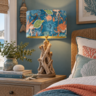 A coastal-themed table lamp with a blue sea-creature patterned drum shade and a driftwood base, styled on a wooden nightstand next to a bed in a bedroom.