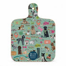 A rectangular wooden cutting board with a rounded handle, featuring a colorful cartoon dog pattern on a mint green background. The design includes various dog breeds, bowls, leashes, and bones.