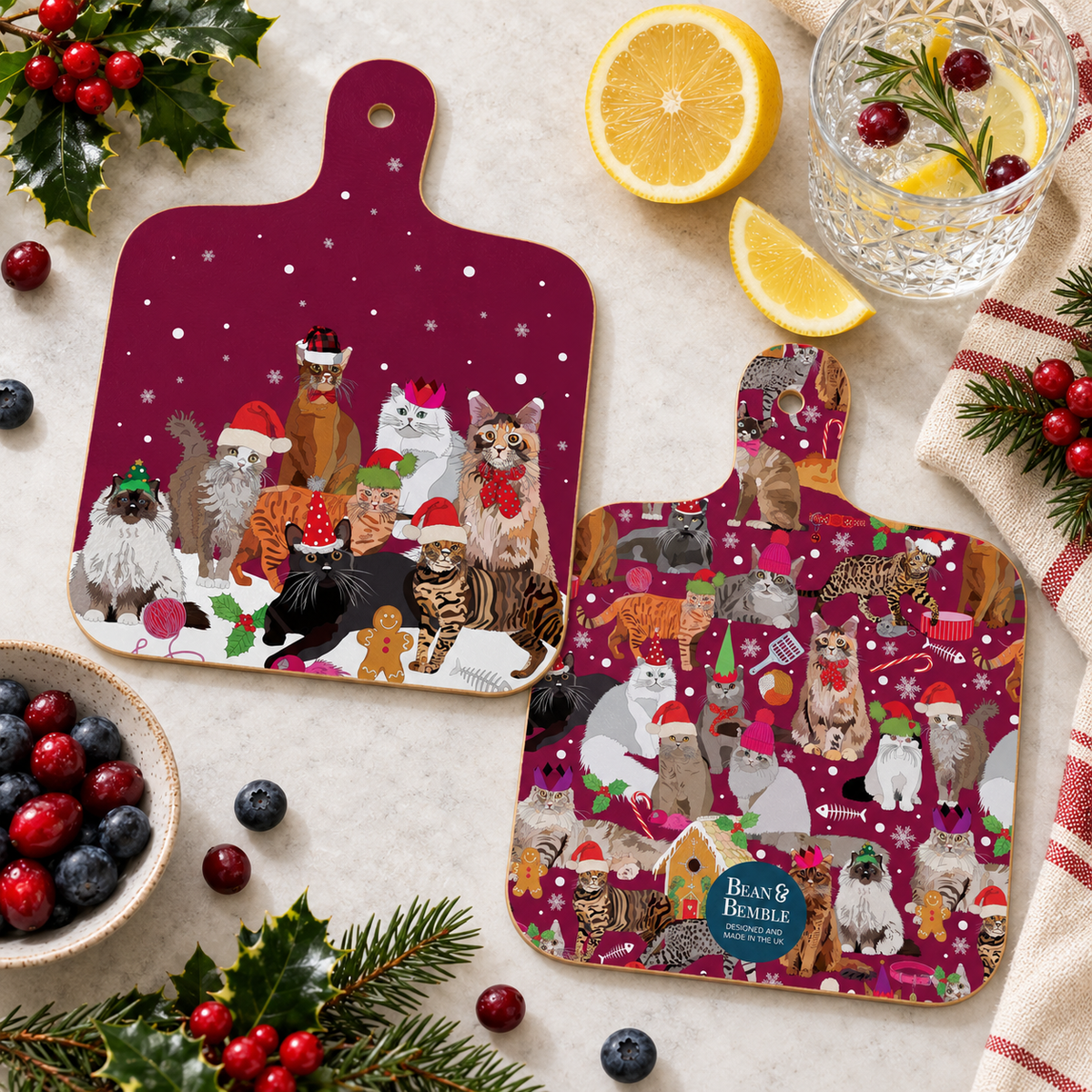 Festive front and back mockup:
Double-sided Christmas Cats mini cutting boards styled with holly, berries, citrus and a festive drink, showing both the cat group design and coordinating all-over Christmas cat pattern.