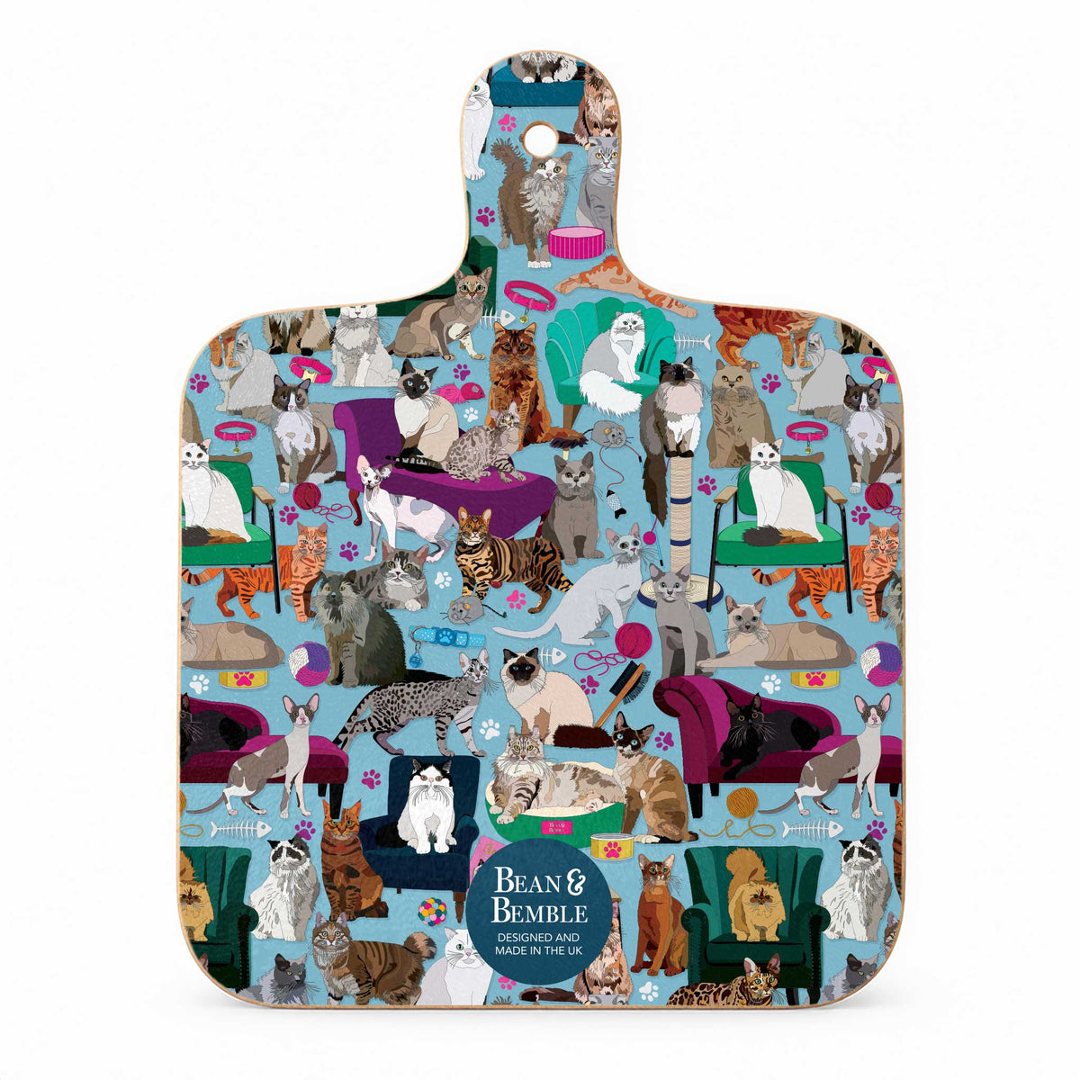 Mini melamine chopping board with a pattern of illustrated cats and cat toys on a blue background.