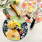 Large round floral chopping board with camellia and leaf illustrations