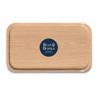 The back of a rectangular wooden tray with rounded corners and a dark navy blue circular logo in the centre that reads 'Bean & Bemble'. The tray has a light oak wood grain finish and is photographed on a clean white background.