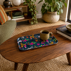 Cherry Blossom navy floral small melamine tray with coffee cup on a wooden coffee table.