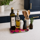 Vivid Blooms small floral melamine tray with cafetière and coffee cup on a light stone coffee table.