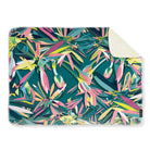 Colourful teal abstract patterned blanket on a white background