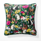 A square throw pillow featuring a vibrant, all-over print of horses and wildflowers on a dark green background, shown against a plain white studio backdrop.