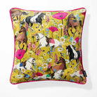 A square decorative throw pillow with a vibrant, detailed print of various horse breeds amidst colorful wildflowers on a mustard yellow background, finished with a bright pink piped edge.