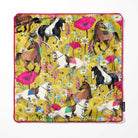 A square cushion cover with a vibrant yellow background, featuring an all-over print of horses in various breeds and colours, surrounded by colourful wildflowers. The cushion cover has bright pink piping and a small black Bean and Bemble brand tag on the bottom right edge.